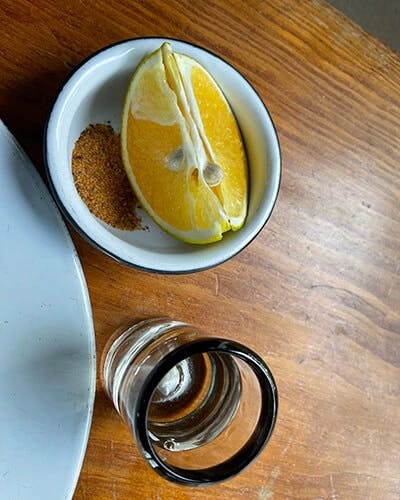 Mezcal is traditionally served with orange slices and sal de gusano, a mixture of salt, dried chiles, and toasted and ground worms from the agave plant. (You really only taste the salt and chiles.)